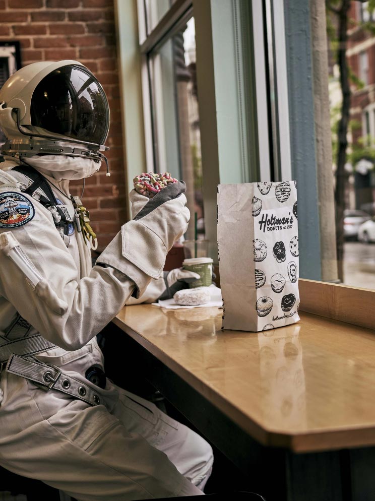 Astronaut holding donut